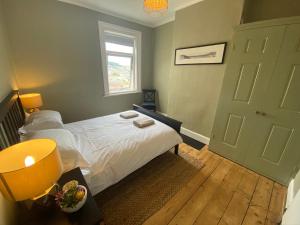 a small bedroom with a bed and a window at Pass The Keys Beautiful 3 Bedroom House with Great Views of Bath in Bath
