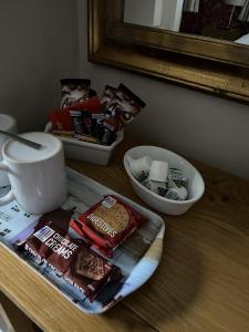 a cup of coffee and a box of cookies on a table at The Castle Tavern in Richmond