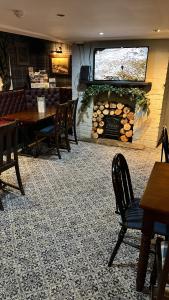 a restaurant with a table and chairs and a fireplace at The Castle Tavern in Richmond