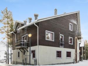 a large brown and white building with a street light at Holiday Home Levin otava 14 by Interhome in Sirkka