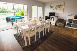 a dining room with a white table and chairs at Golf and Tennis ~ Edgewater Escape in Wesley Chapel