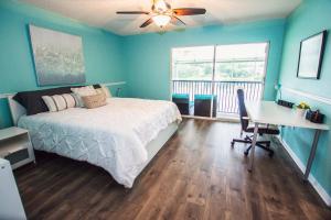 a bedroom with a bed and a desk and a window at Golf and Tennis ~ Edgewater Escape in Wesley Chapel