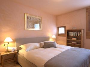 a bedroom with a bed and a book shelf at Apartment Chesa Maurus A5 by Interhome in St. Moritz