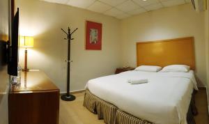a bedroom with a large white bed in a room at Golden Court Hotel - Sri Pelangi in Johor Bahru