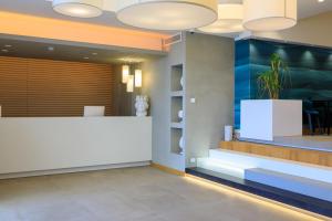 an office lobby with a white reception desk at Albatros Beach Hotel in Letojanni +163 photos
