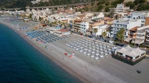 an aerial view of a beach with umbrellas and the ocean at Albatros Beach Hotel in Letojanni