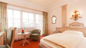 Rúm í herbergi á Superior Hotel Tirolerhof - Zell am See