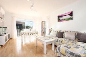 a living room with a couch and a table at Marcos Apartment in Port de Pollensa