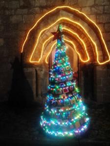 a christmas tree with lights in a room at La Roulotte De Lola - Chambre d'hôtes in La Celle