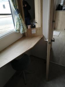 a wooden desk in a room with a window at 69R Seawick 2 Bedroom Caravan . New for 2022 in Saint Osyth