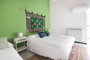 Postel nebo postele na pokoji v ubytování Iconic Apartment in Porta Carini by Wonderful Italy