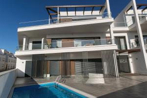 a house with a swimming pool in front of it at Salty Soul in Ferrel