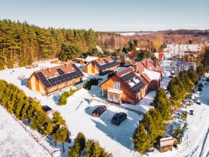 an aerial view of a resort in the snow at Malinowy Dworek - Spokojny wypoczynek nad morzem in Ciekocino