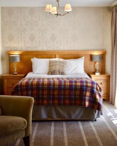 a bedroom with a bed with a colorful blanket at The Coledale Inn in Keswick