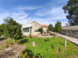 a house with a garden in front of it at Casa do Lago da Quinta de Esteves in Ponte de Lima