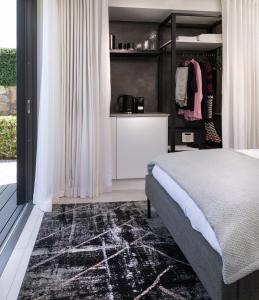 a bedroom with a bed and a closet at PREMIUM CAPE Camps Bay Lodge in Cape Town +58 photos