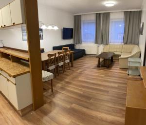 a living room with a kitchen and a dining room at Kaiser-Franz in Bad Hofgastein