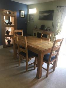 a wooden table with two chairs and a dining room at Silverstone Bed and Breakfast in Silverstone