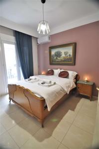 a bedroom with a large bed and a window at Zennova #4 Vintage City Center Apt in Thessaloniki