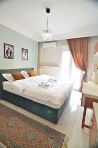 a bedroom with a large bed in a room at Zennova #4 Vintage City Center Apt in Thessaloniki