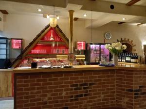a bar in a restaurant with a brick wall at Gästehaus Zum Salztrippler in Rumbach +17 photos