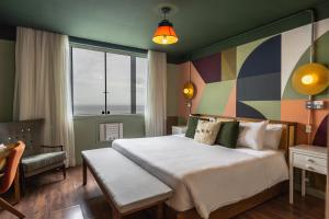 
A bed or beds in a room at Selina Copacabana
