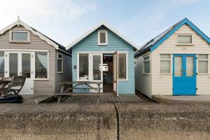 two blue and white homes on a dock at Stargazing Beach Hut on Mudeford Sandbank with wake up sea views in Christchurch