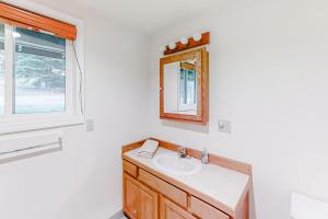 a bathroom with a sink and a mirror and a window at Glacier Lake in Joseph +14 photos