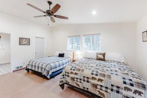 a bedroom with two beds and a ceiling fan at Glacier Lake in Joseph