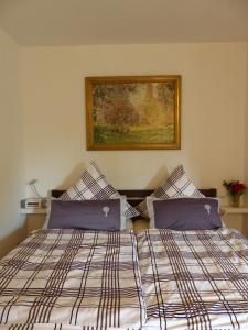 a bedroom with a bed and a picture on the wall at Schwarzwaldturmzimmer Lahr in Lahr