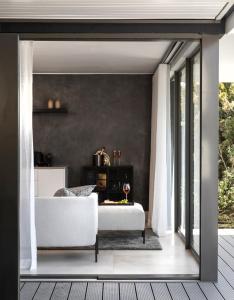 a living room with a white couch and a window at PREMIUM CAPE Camps Bay Lodge in Cape Town