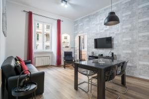 a living room with a table and a couch at NEW! Completely renovated apt in Vatican! in Rome