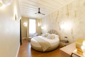 a bedroom with a large white bed in a room at Castellano Hotel & Suites in Nafplio