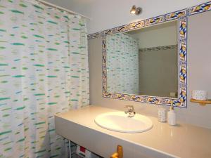 a bathroom with a sink and a mirror at La Silla de la Reina in Navarredonda de Gredos