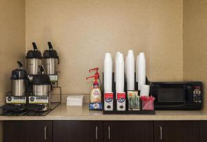 a kitchen counter with a microwave and a coffee maker at Red Roof Inn PLUS+ Boston - Woburn/ Burlington in Woburn