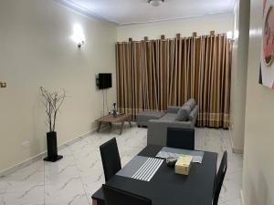 a living room with a couch and a table at Jaffa Suites in Kampala