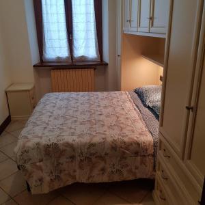 Schlafzimmer mit einem Bett und einem Fenster in der Unterkunft Via Sacco in Aosta