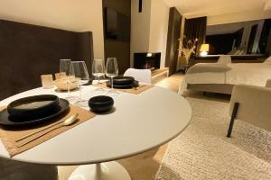 a white table in a room with a bedroom at Le19 Gîte Urbain in Namur