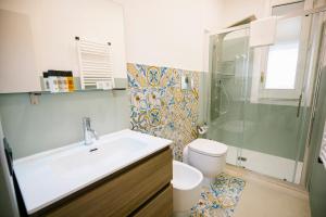 a bathroom with a sink and a shower and a toilet at Villa Calipso in Mondello
