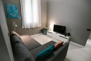 a living room with a couch and a flat screen tv at Villa Calipso in Mondello