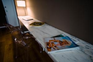 a table with a book and a lamp on top of it at Villa Calipso in Mondello