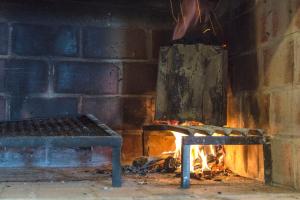 a fireplace with a bench next to a brick wall at Altos de Manantiales in El Calafate