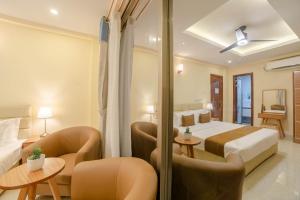 Postel nebo postele na pokoji v ubytování Amber Beach Hotel