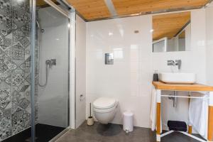 a bathroom with a shower and a toilet and a sink at Monreal Boutique Townhouse - R024RM5 in Paola