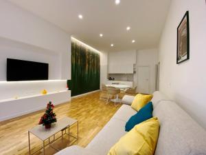 a living room with a couch and a christmas tree at STAY home experience in Perugia