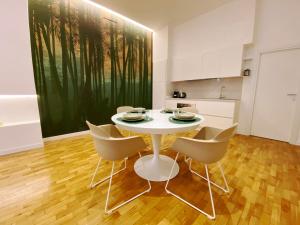 a dining room with a white table and chairs at STAY home experience in Perugia