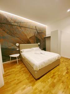 a bedroom with a bed and a painting on the wall at STAY home experience in Perugia