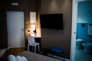 a hotel room with a small table and a television at Villa Calipso in Mondello