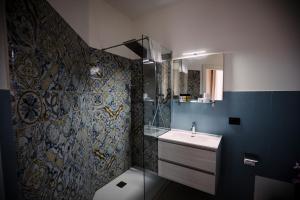 a bathroom with a sink and a shower at Villa Calipso in Mondello