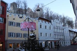 a street with a christmas tree in front of a building at Hotel Krone in Brunico